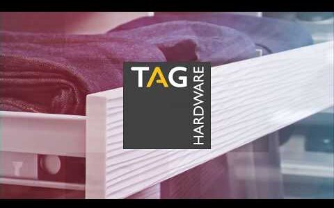 The logo of TAG Hardware displayed on a furniture