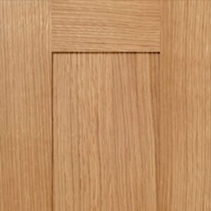 A close-up view of a S116 GOLD COAST cabinet door with visible grain and handle cut-outs.