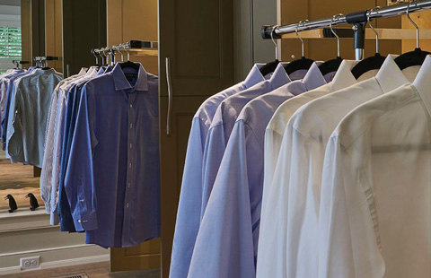 Shirts beautifully arranged inside a wall cabinet