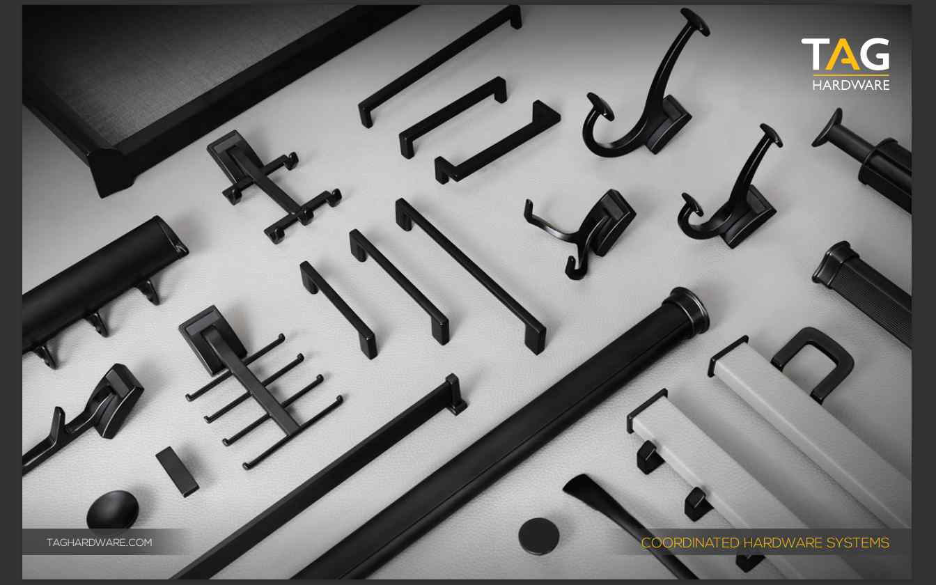 An assortment of black cabinet hardware items neatly displayed on a white surface, showcasing various hooks and handles for custom cabinet projects.