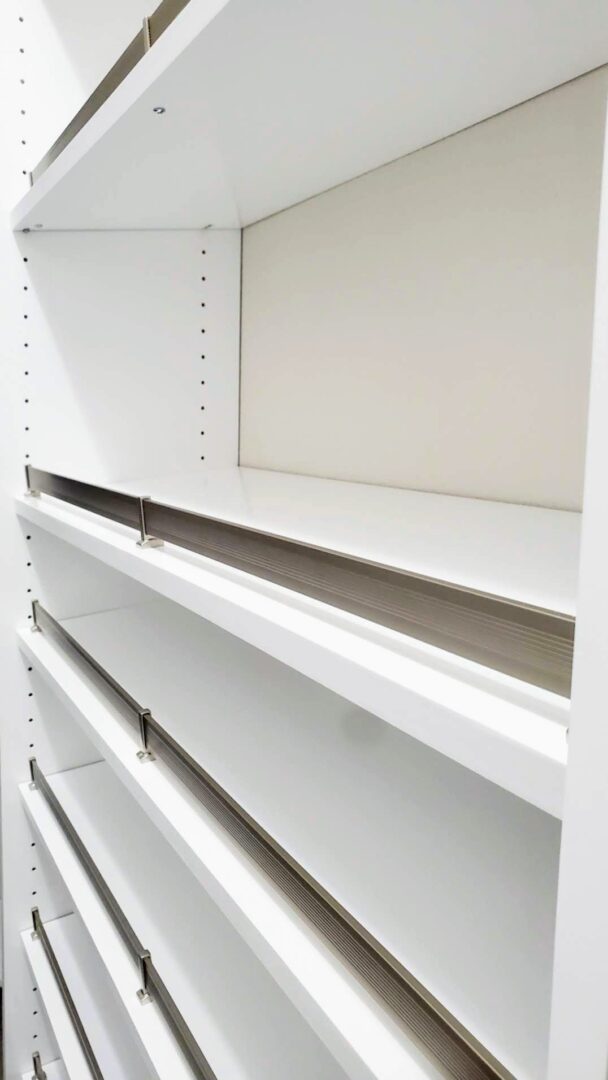 Empty white shelves against a plain wall, now featuring exceptional custom furnishing.