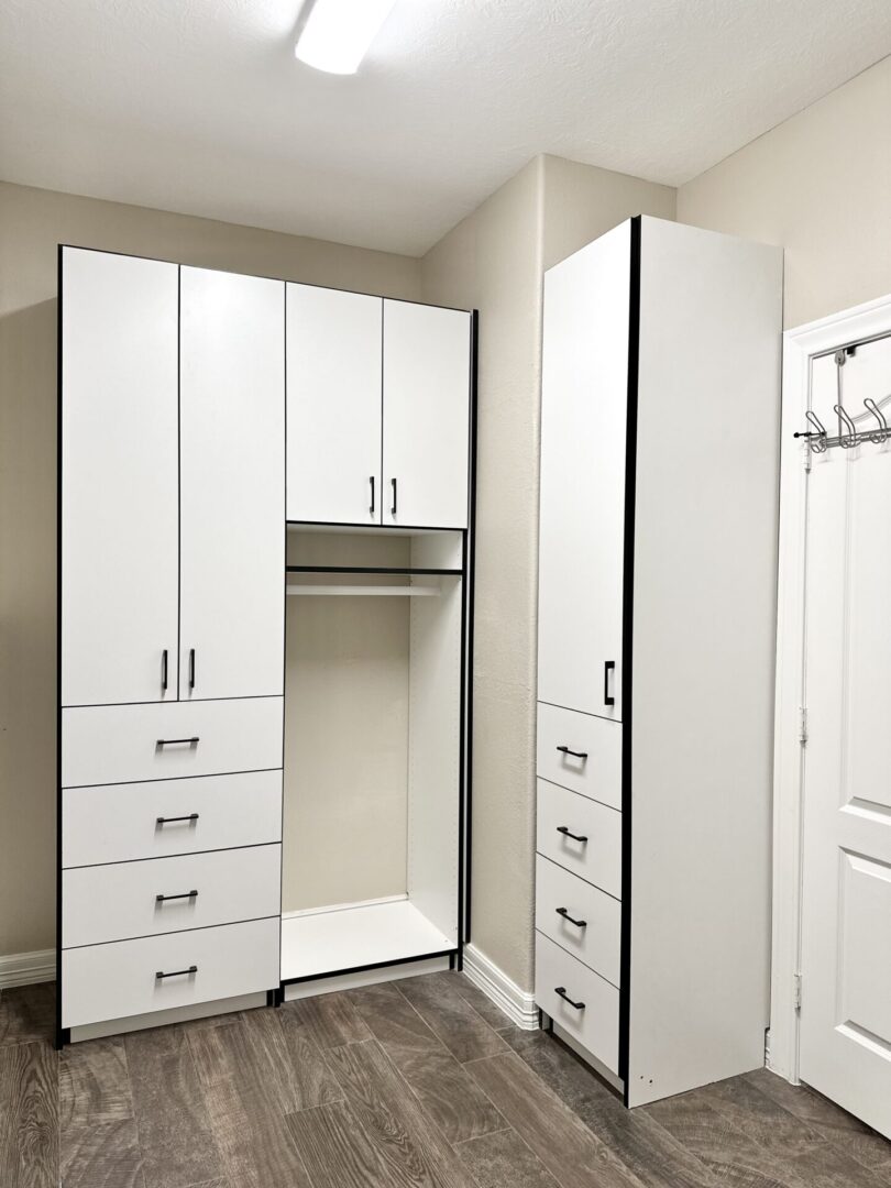 White built-in closet and storage system in a modern room.