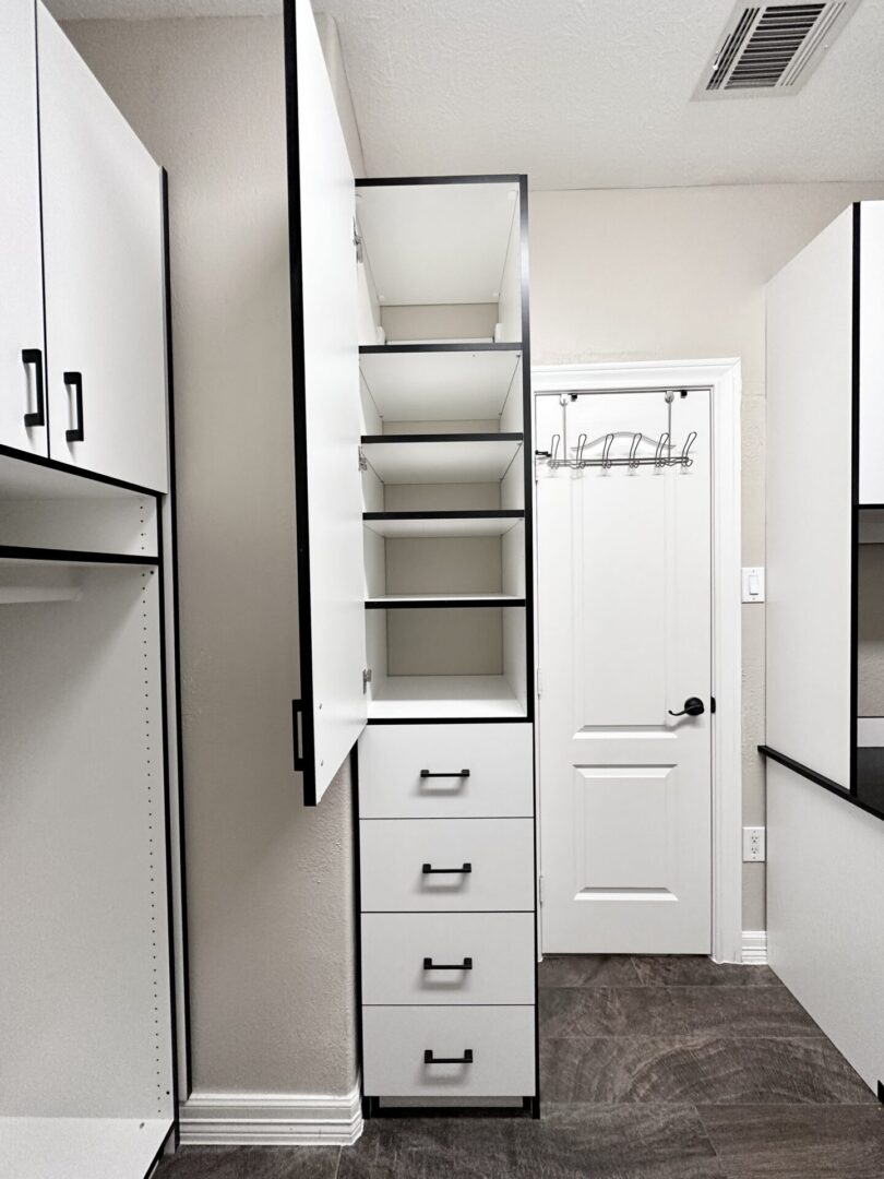 Modern walk-in closet with open storage system and pull-out drawers.