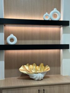 Modern interior shelf decor with minimalist vases and an exceptional ornamental bowl.