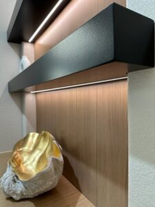 Exceptional Custom Furnishing: Decorative shelf with an illuminated ledge showcasing a gold-lined geode.