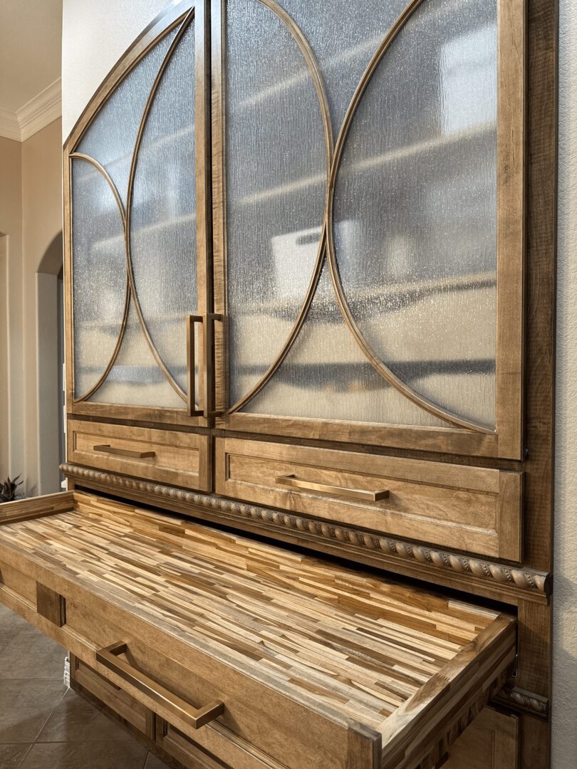 A textured wooden sideboard with geometric glass panel doors.